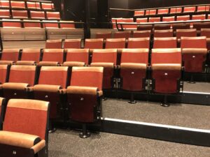 image of upholstered leather fixed auditorium seating with custom rotating pedestal at the bridge theatre